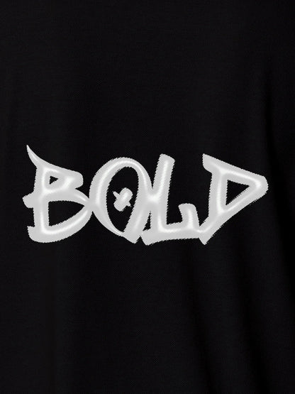 Close up of 'Bold' on Women's Black Polo T-shirt, highlighting intricate details and vibrant print.