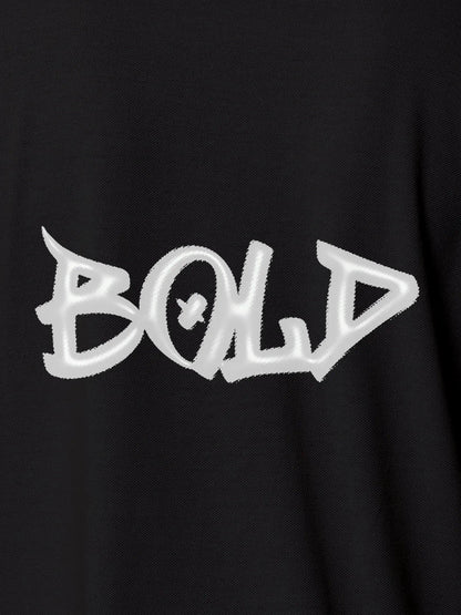 Close up of 'Bold' on Women's Dark Grey Polo T-shirt, highlighting intricate details and vibrant print.
