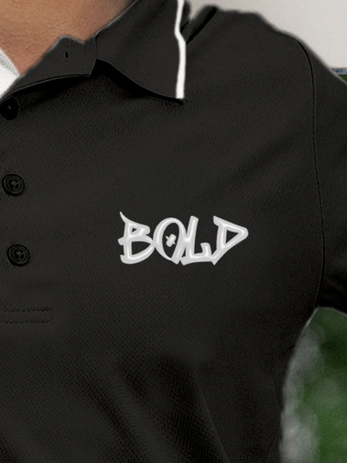 Close up of 'Bold' on Women's Dark Grey Polo T-shirt, highlighting intricate details and vibrant print.