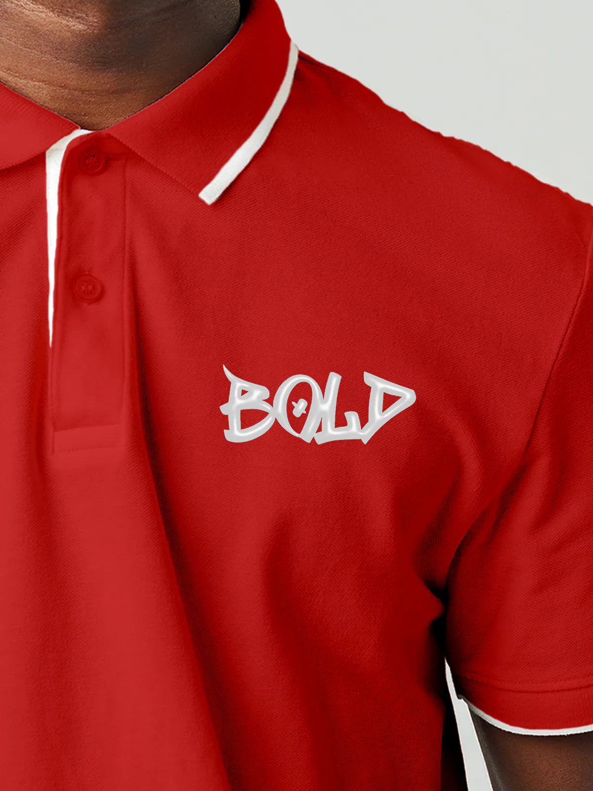 Close up of 'Bold' on Men's Red Polo T-shirt, highlighting intricate details and vibrant print.