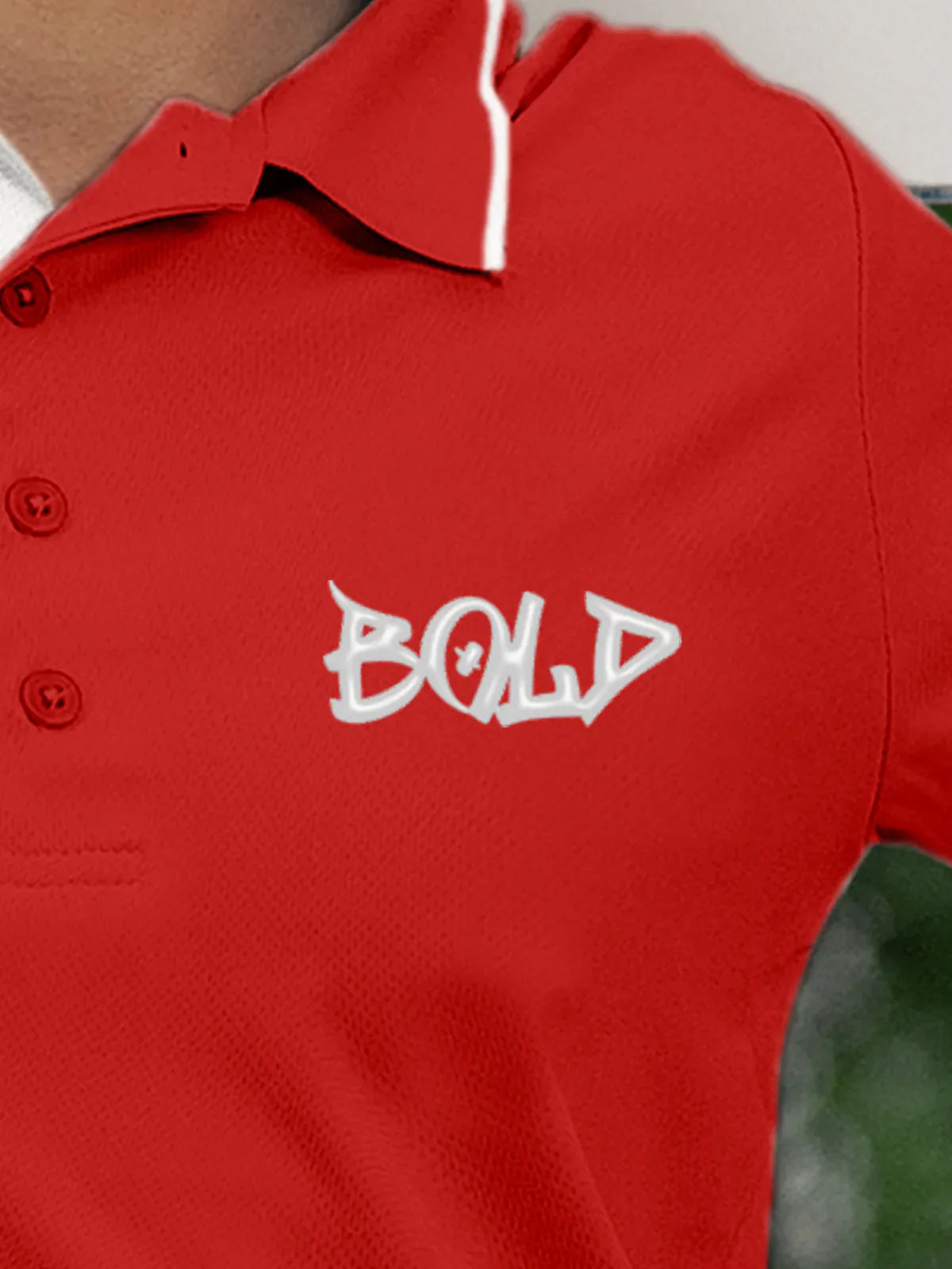 Close up of 'Bold' on Women's Red Polo T-shirt, highlighting intricate details and vibrant print.