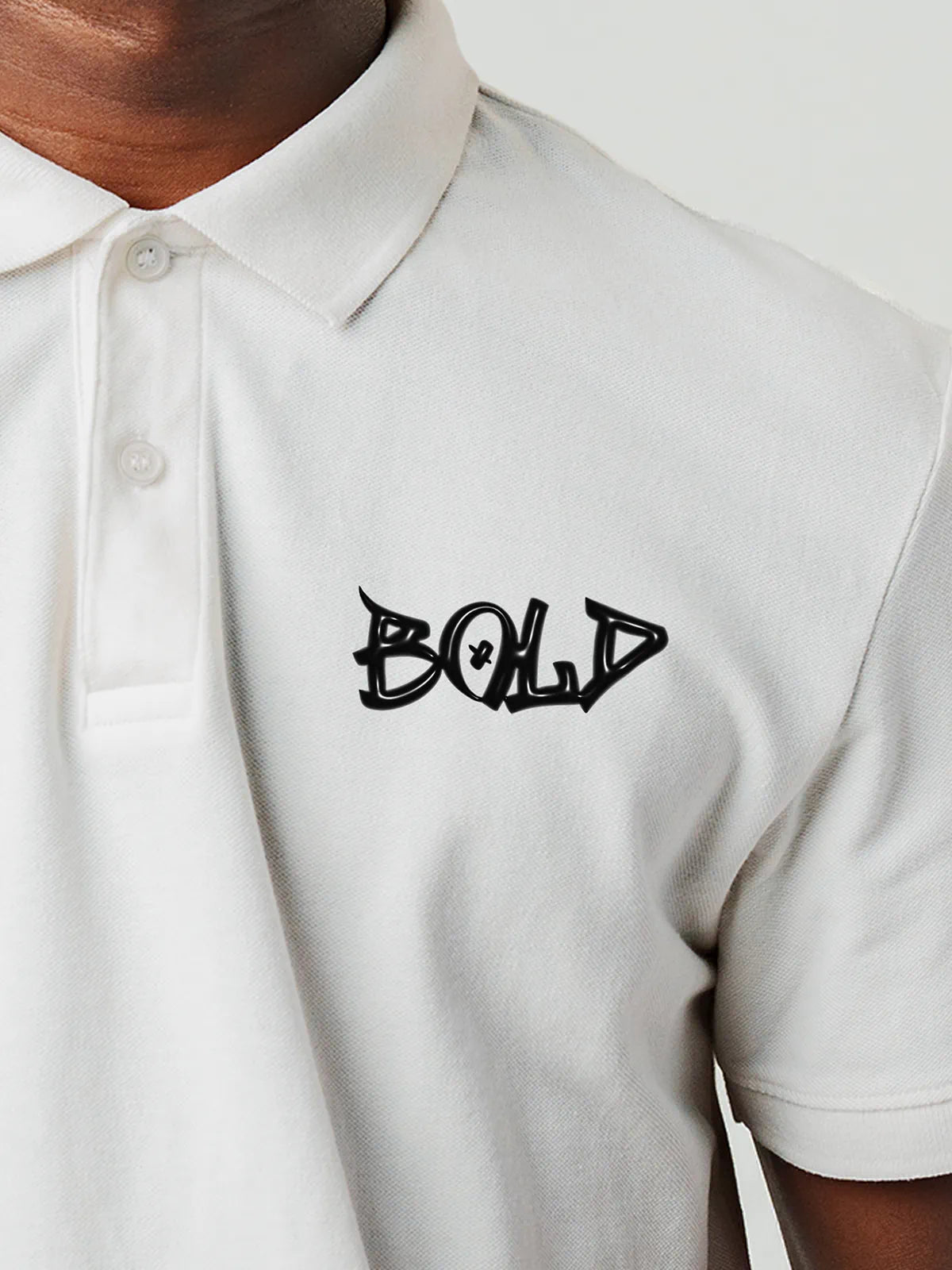 Close up of 'Bold' on Men's White Polo T-shirt, highlighting intricate details and vibrant print.
