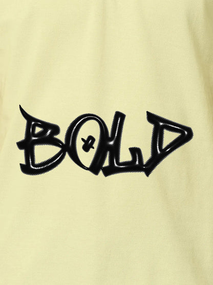 Close up of 'Bold' on Men's Yellow Polo T-shirt, highlighting intricate details and vibrant print.