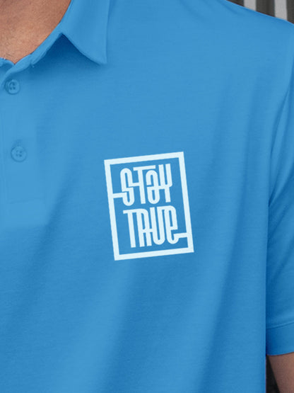 Close up of 'Stay True' design on Men's Blue Polo T-shirt, highlighting intricate details and vibrant print.