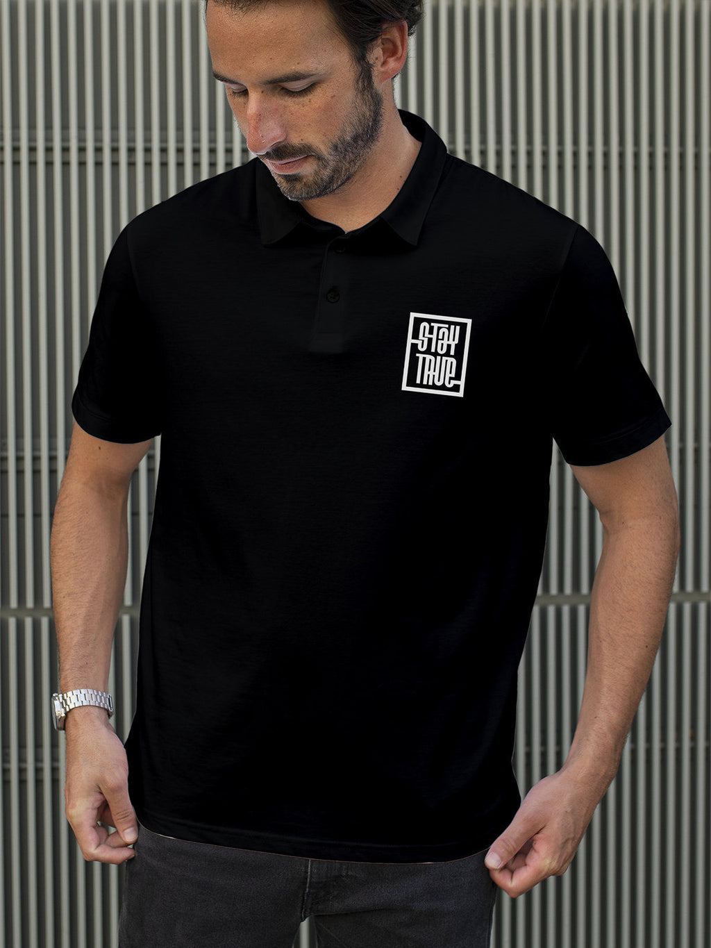 Model wearing Men's Black Polo T-shirt with 'Stay True' design, offering effortless style and premium comfort