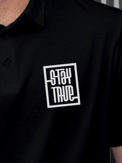 Close up of 'Stay True' design on Men's Black Polo T-shirt, highlighting intricate details and vibrant print.