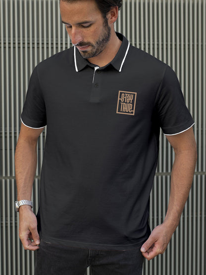 Model wearing Men's Dark Grey Polo T-shirt with 'Stay True' design, offering effortless style and premium comfort