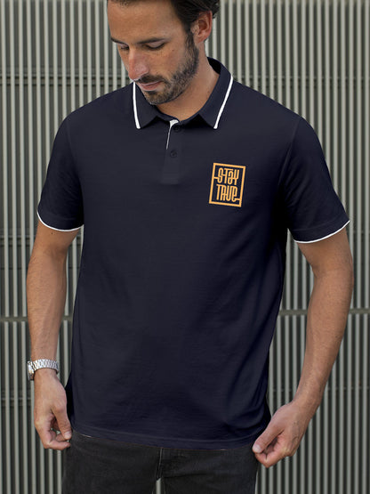 Model wearing Men's Navy Blue Polo T-shirt with 'Stay True' design, offering effortless style and premium comfort