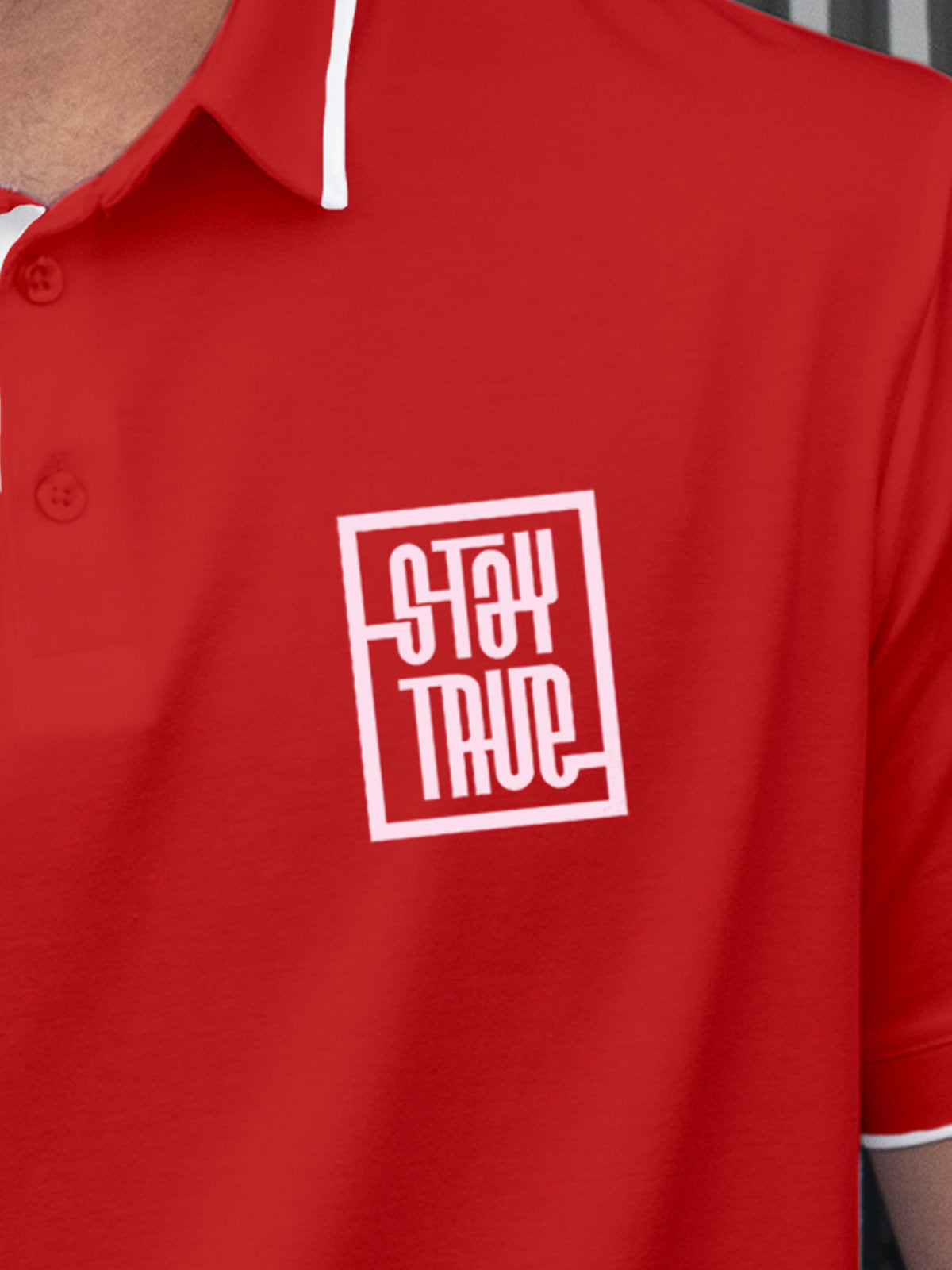 Close up of 'Stay True' on Men's Red Polo T-shirt, highlighting intricate details and vibrant print.