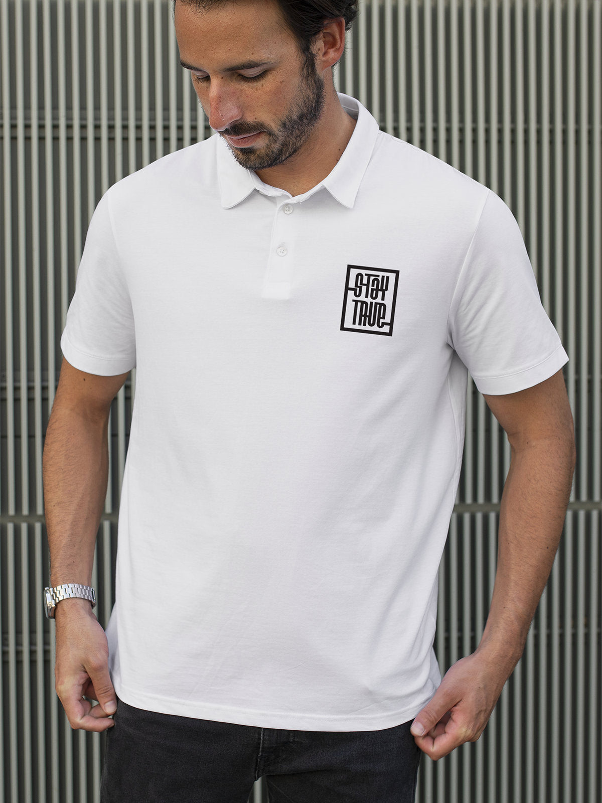 Model wearing Men's White Polo T-shirt with Stay True, offering effortless style and premium comfort