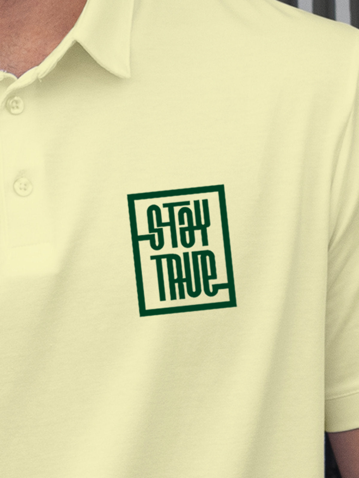 Close up of 'Stay True' on Men's Yellow Polo T-shirt, highlighting intricate details and vibrant print.