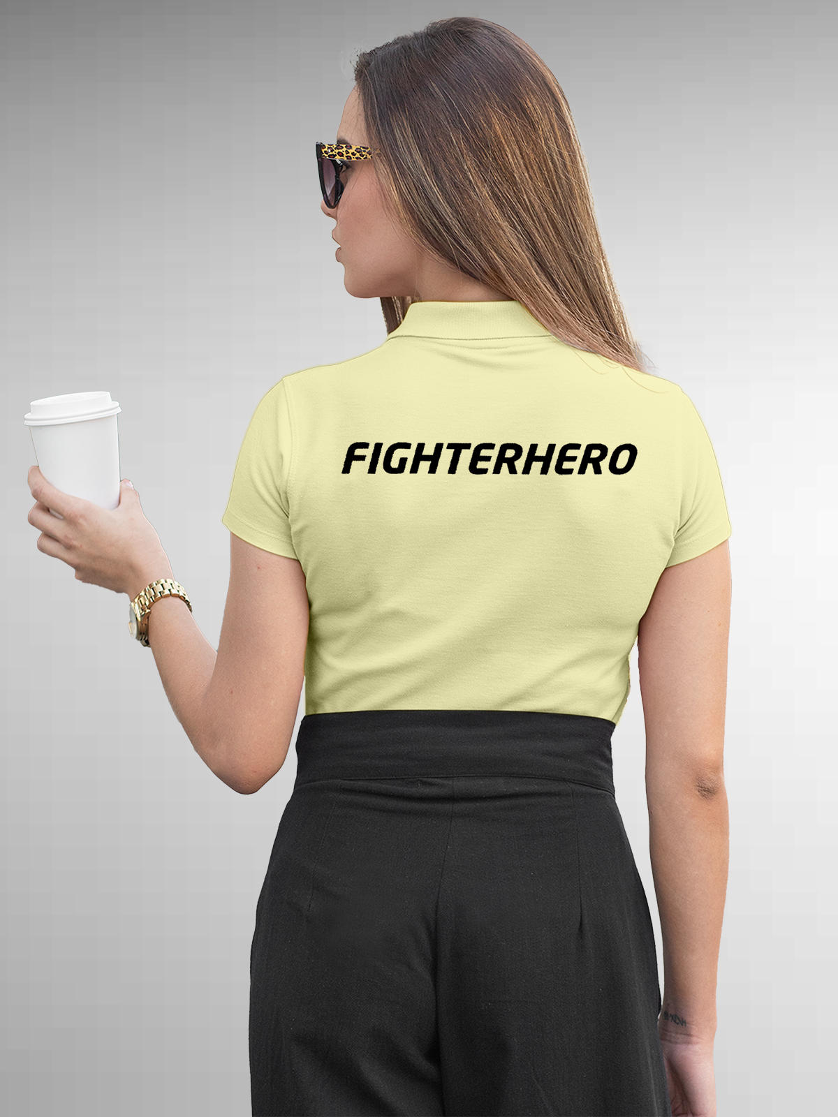 Model wearing Women's Yellow Polo T-shirt with 'Fighterhero' design, offering effortless style and premium comfort