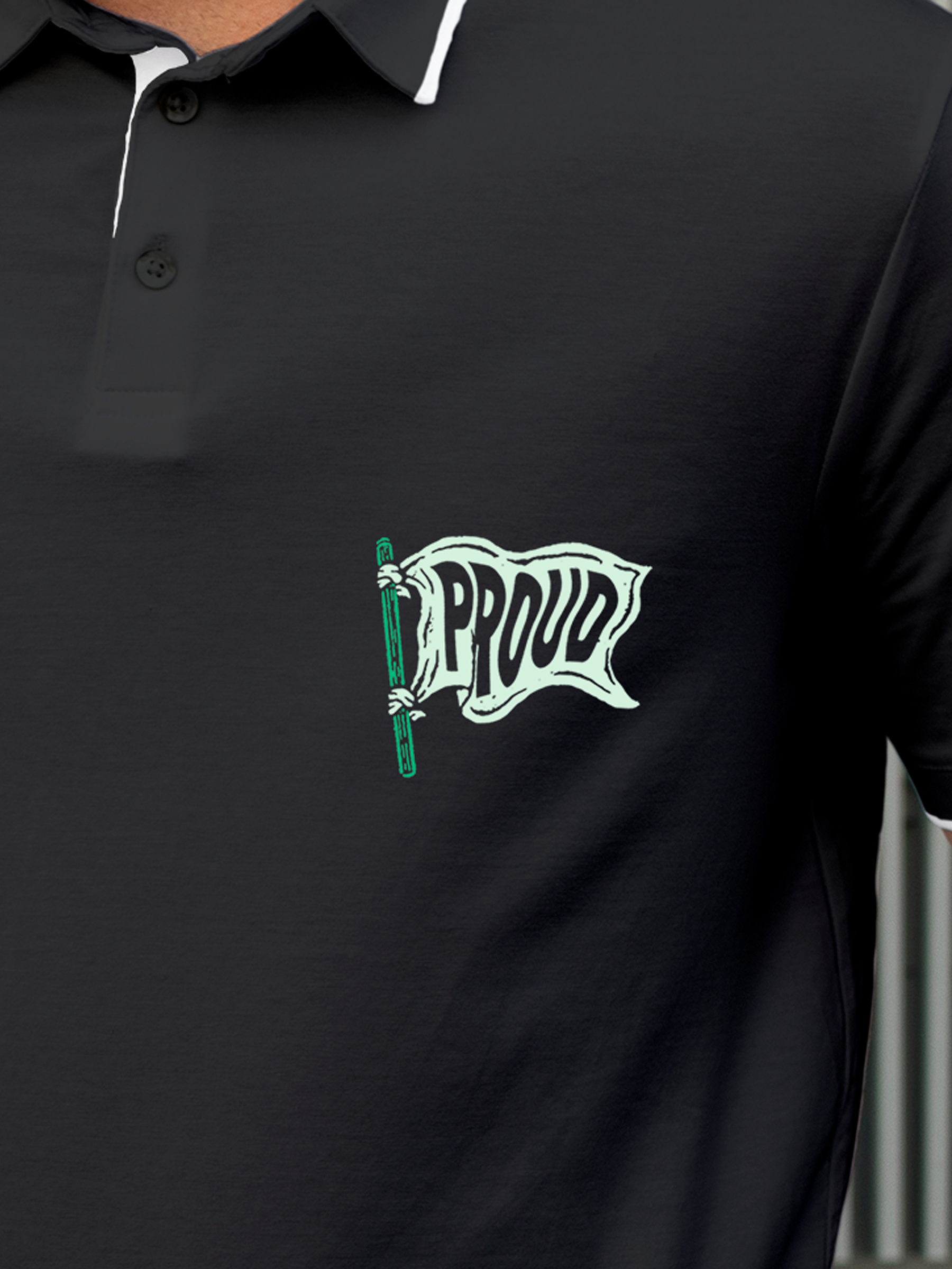 Close up of 'Proud' design on Men's Charcoal Grey Polo T-shirt, highlighting intricate details and vibrant print.