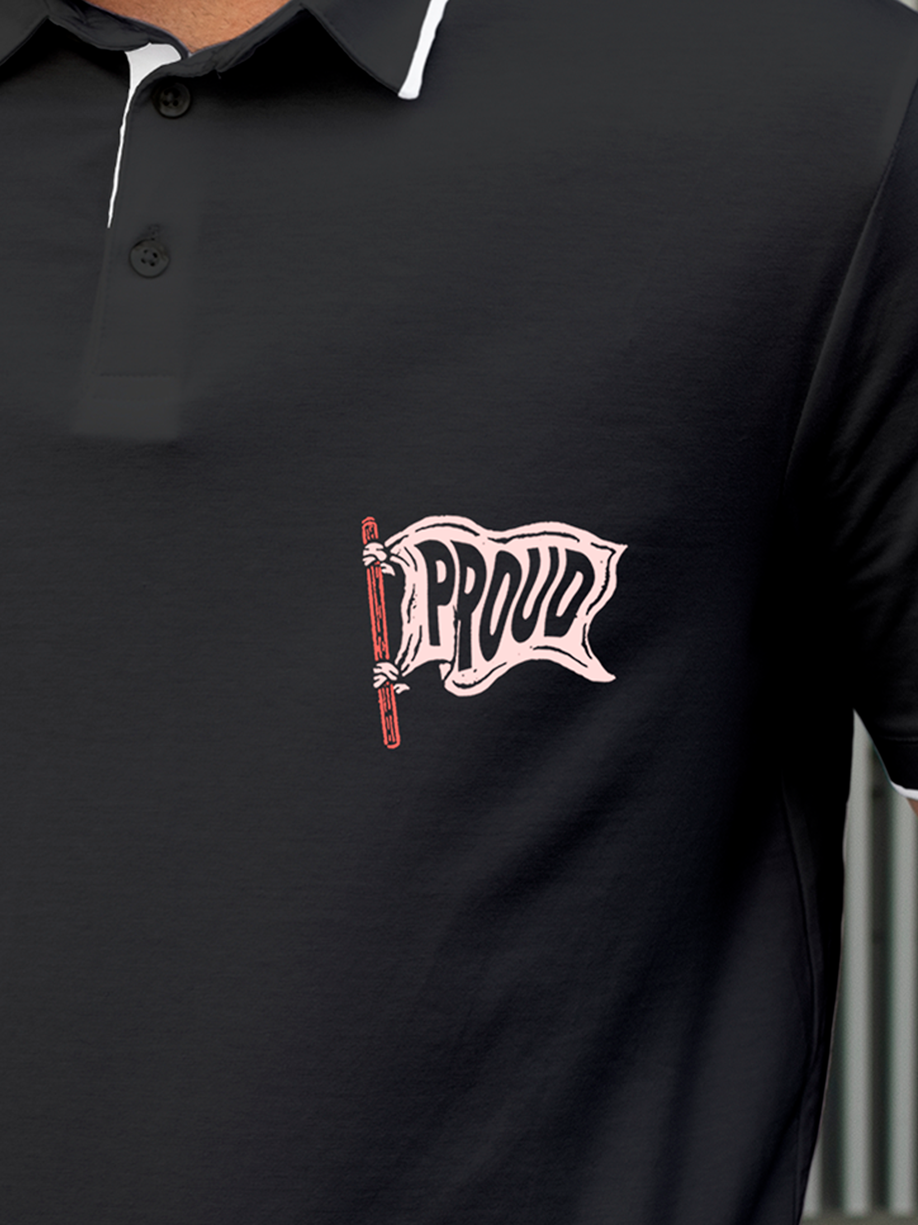 Close up of 'Proud' design on Men's Charcoal Grey Polo T-shirt, highlighting intricate details and vibrant print.