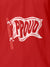 Close up of 'Proud' design on Women's Red Polo T-shirt, highlighting intricate details and vibrant print.