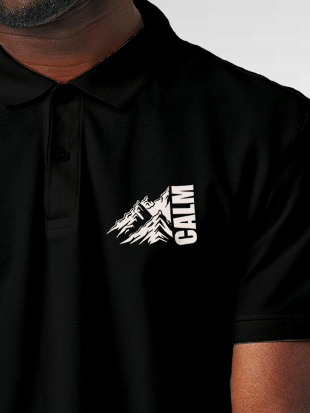 Close up of 'Calm' design on Men's Black Polo T-shirt, highlighting intricate details and vibrant print.
