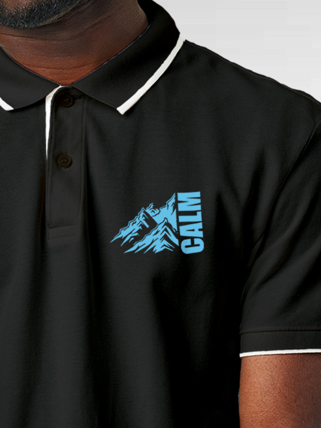 Close up of 'Calm' design on Men's Dark Grey Polo T-shirt, highlighting intricate details and vibrant print.