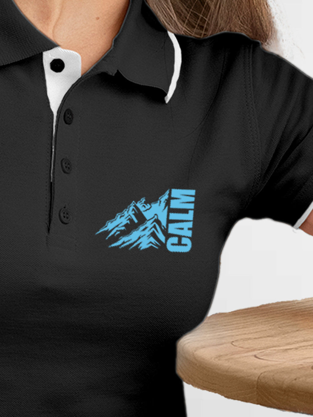 Close up of 'Calm' design on Women's Dark Grey Polo T-shirt, highlighting intricate details and vibrant print.