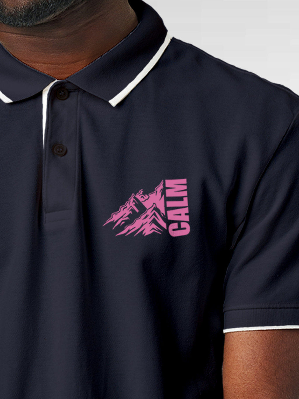 Close up of 'Calm' design on Men's Navy Blue Polo T-shirt, highlighting intricate details and vibrant print.