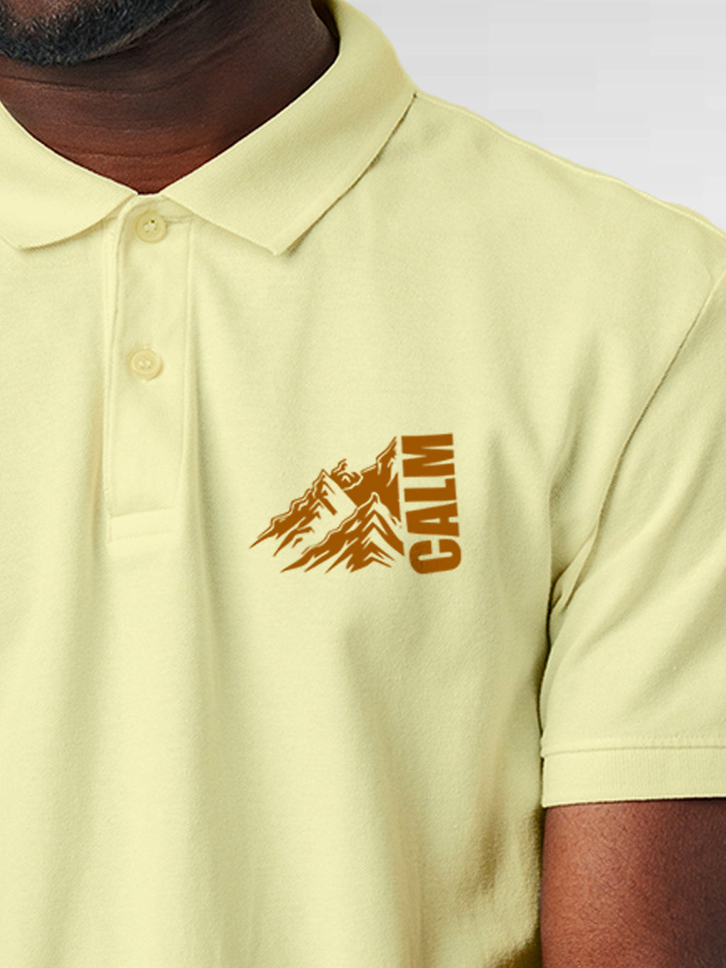 Close up of 'Calm' design on Men's Yellow Polo T-shirt, highlighting intricate details and vibrant print.