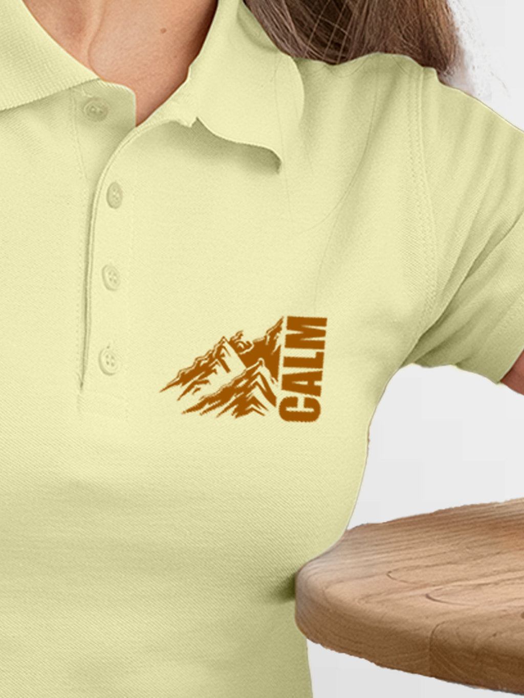 Close up of 'Calm' design on Women's Yellow Polo T-shirt, highlighting intricate details and vibrant print.