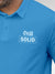 Close up of 'Still Solid' design on Men's Blue Polo T-shirt, highlighting intricate details and vibrant print.