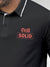 Close up of 'Still Solid' design on Men's Dark Grey Polo T-shirt, highlighting intricate details and vibrant print.