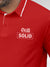 Close up of 'Still Solid' design on Men's Red Polo T-shirt, highlighting intricate details and vibrant print.