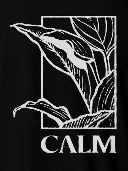 Close up of 'Calm' design on Women's Black Polo T-shirt, highlighting intricate details and vibrant print.