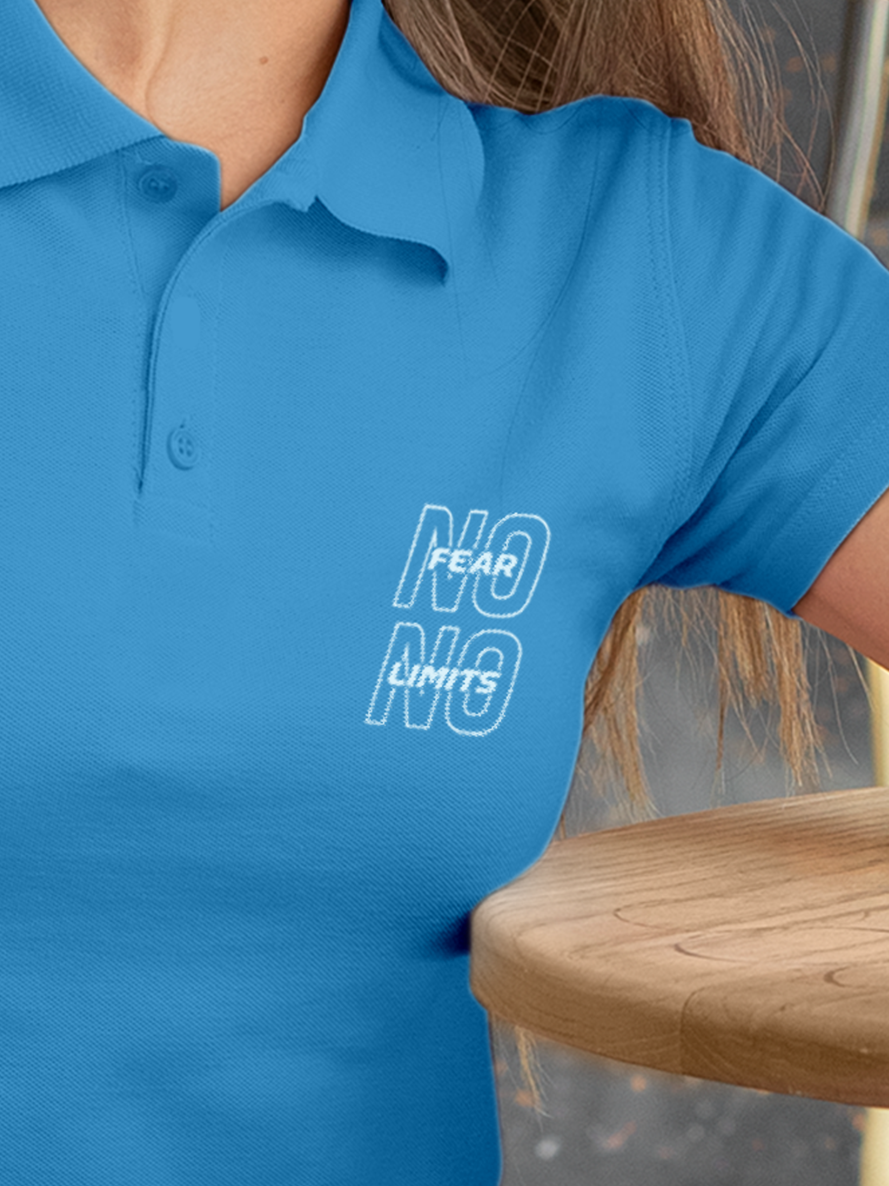 Close up of 'No Fear No Limits' design on Women's Blue Polo T-shirt, highlighting intricate details and vibrant print.
