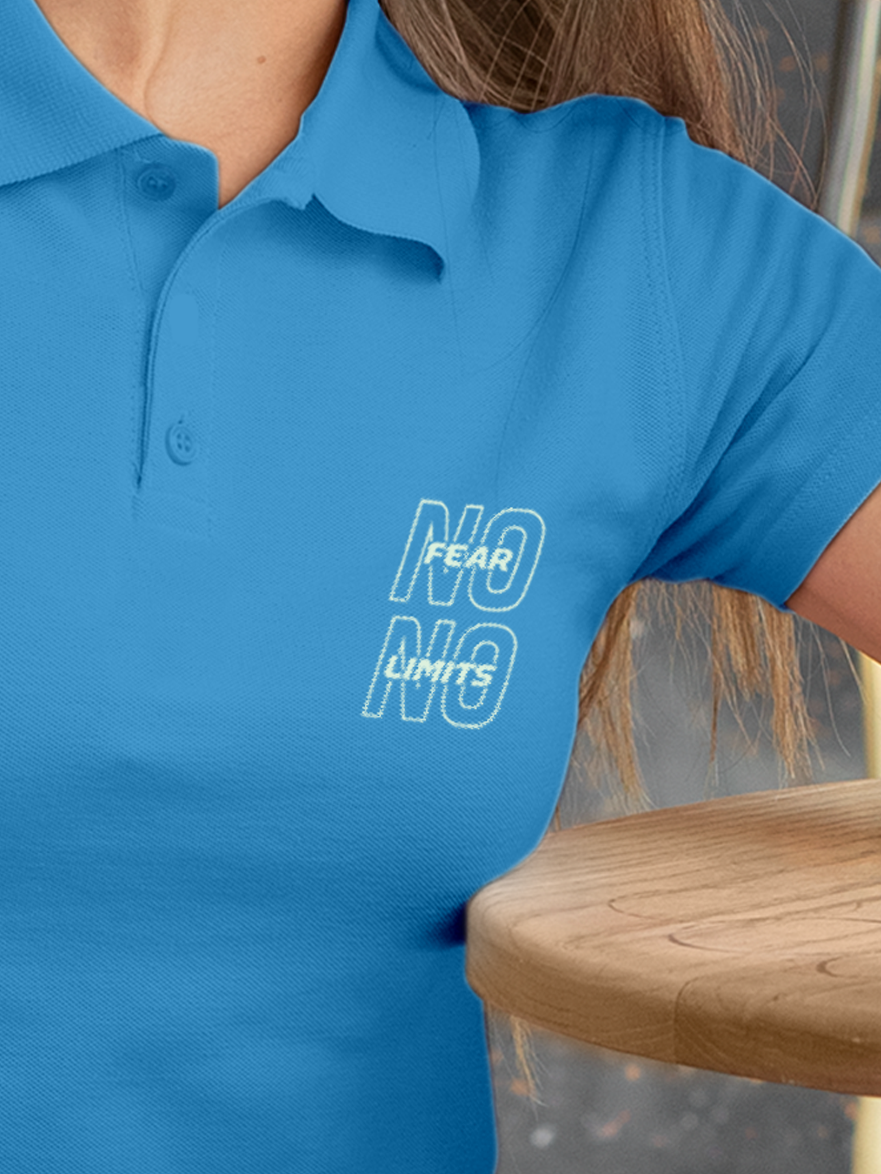 Close up of 'No Fear No Limits' design on Women's Blue Polo T-shirt, highlighting intricate details and vibrant print.