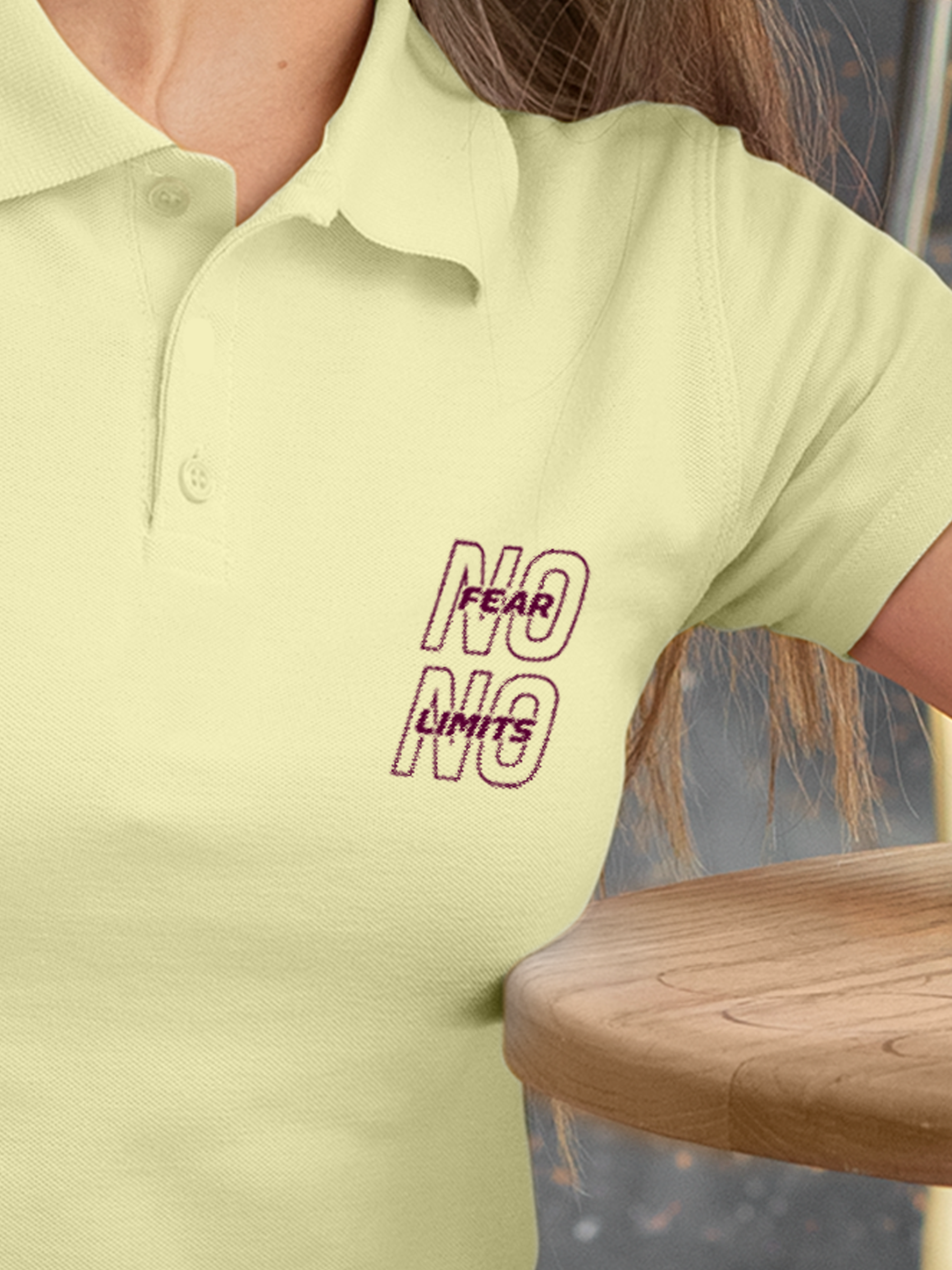 Close up of 'No Fear No Limits' design on Women's Yellow Polo T-shirt, highlighting intricate details and vibrant print.