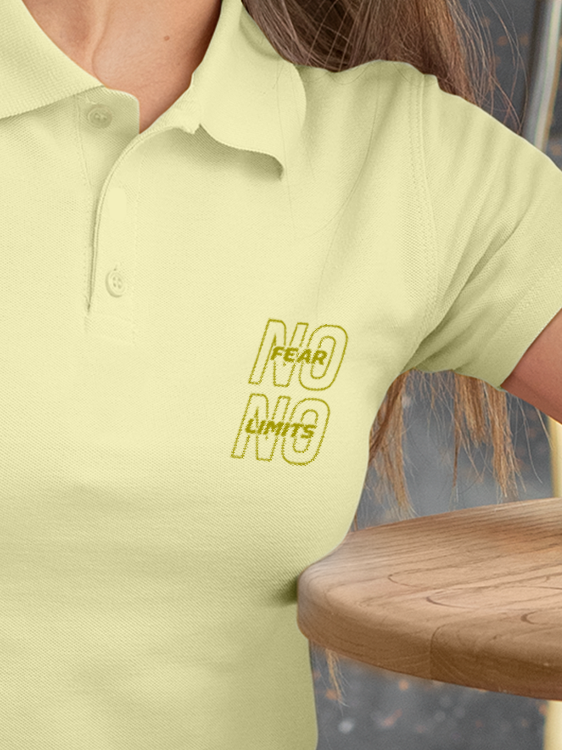 Close up of 'No Fear No Limits' design on Women's Yellow Polo T-shirt, highlighting intricate details and vibrant print.