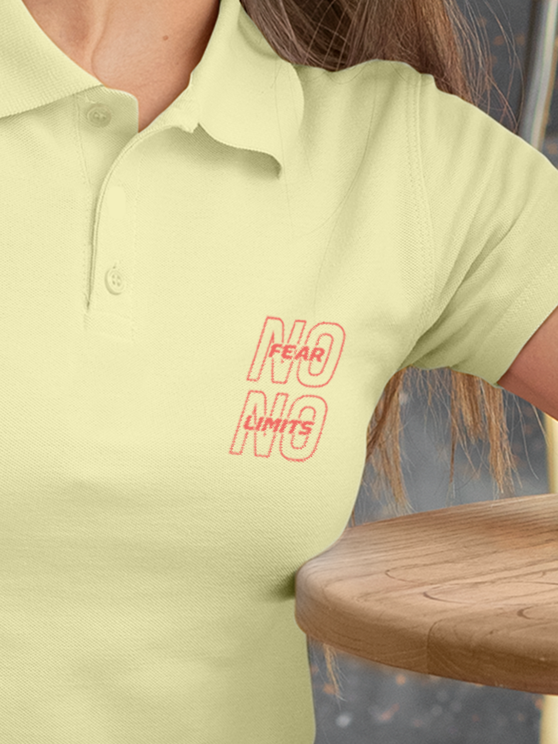 Close up of 'No Fear No Limits' design on Women's Yellow Polo T-shirt, highlighting intricate details and vibrant print.