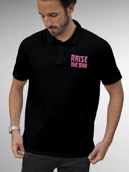 Model wearing Men's Black Polo T-shirt with 'Raise The Bar' design, offering effortless style and premium comfort