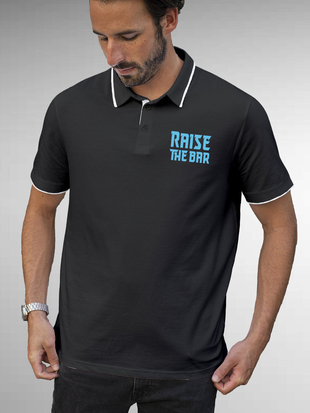 Model wearing Men's Dark Grey Polo T-shirt with 'Raise The Bar' design, offering effortless style and premium comfort