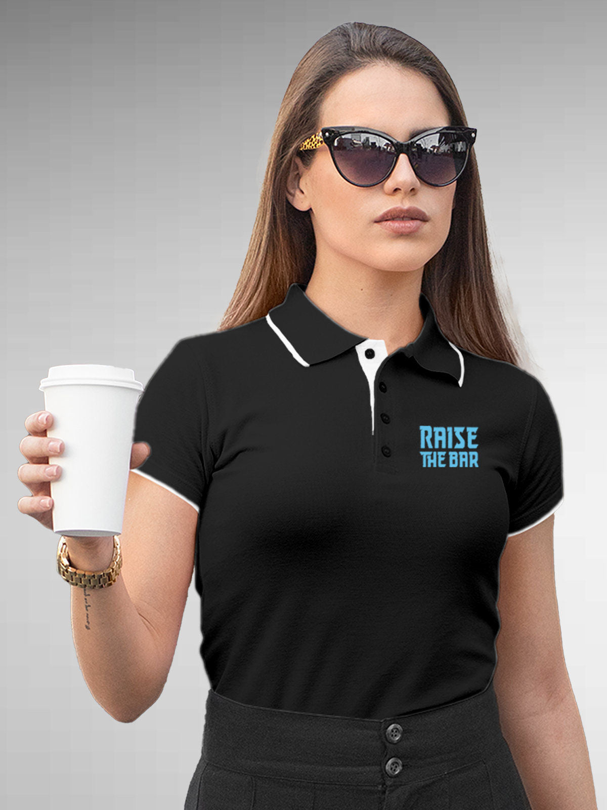 Model wearing Women's Dark Grey Polo T-shirt with 'Raise The Bar' design, offering effortless style and premium comfort