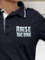 Close up of 'Raise The Bar' design on Women's Navy Blue Polo T-shirt, highlighting intricate details and vibrant print.