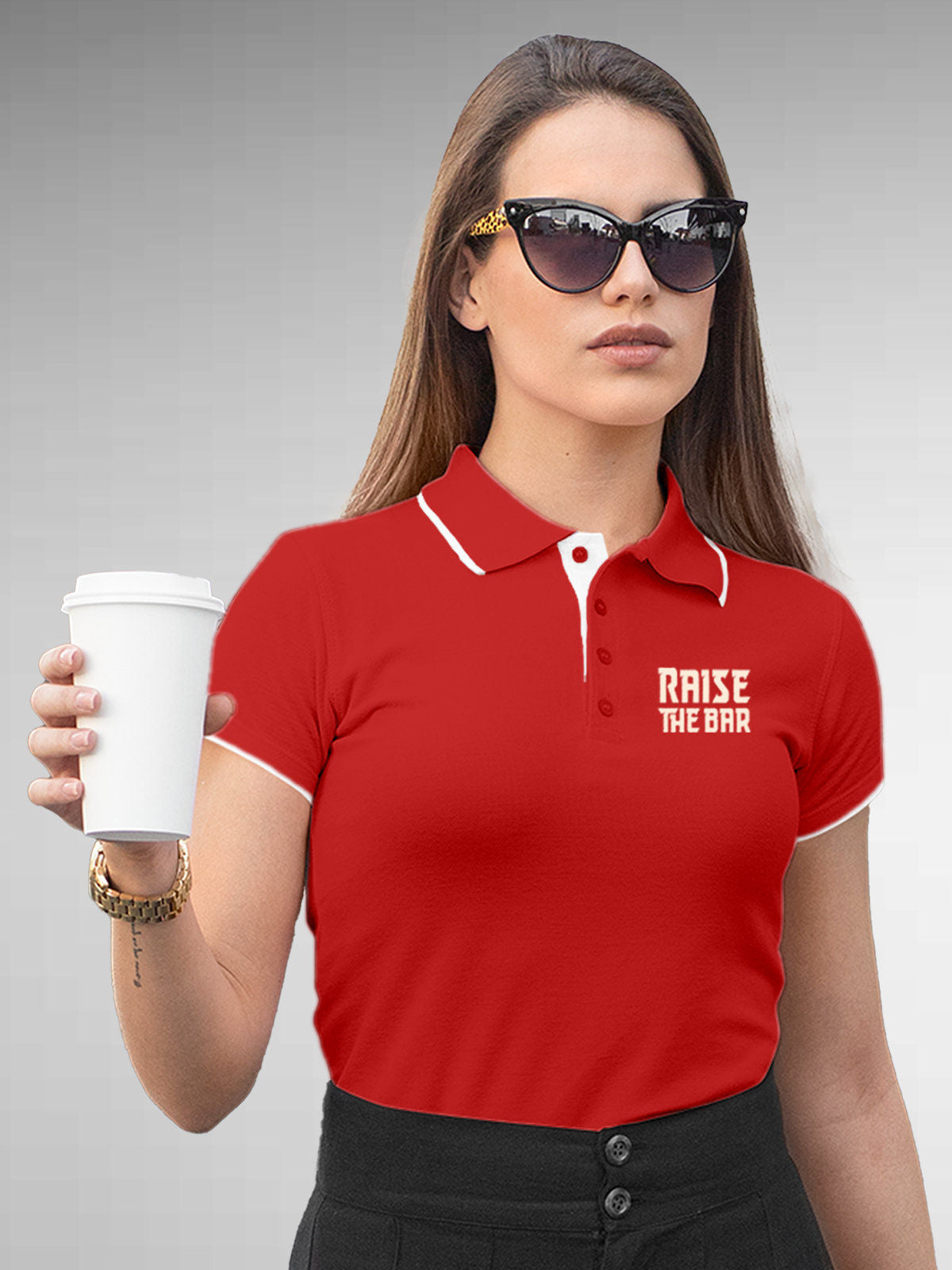 Model wearing Women's Red Polo T-shirt with 'Raise The Bar' design, offering effortless style and premium comfort