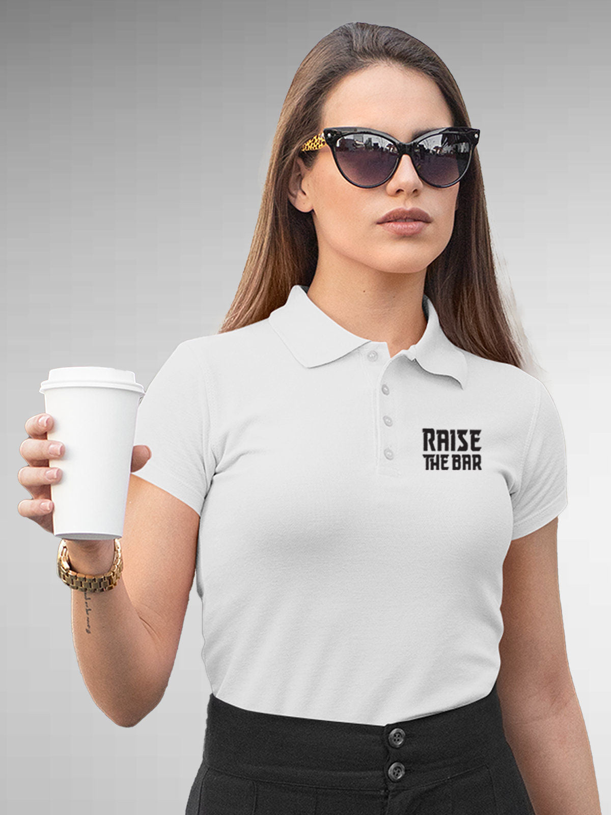 Model wearing Women's White Polo T-shirt with 'Raise The Bar' design, offering effortless style and premium comfort