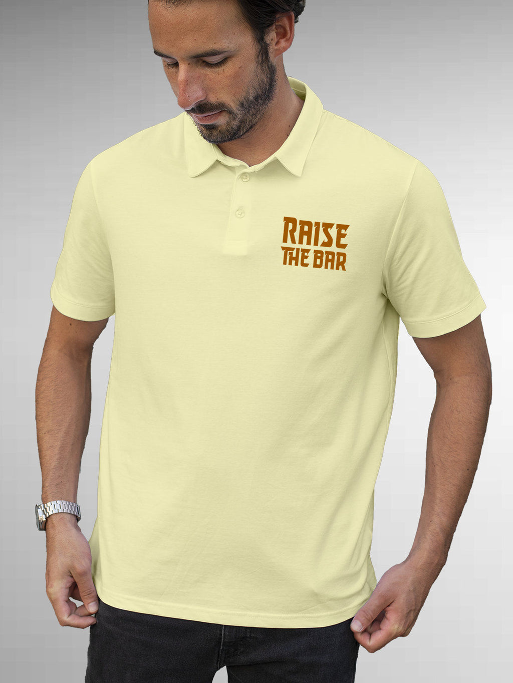 Model wearing Men's Yellow Polo T-shirt with 'Raise The Bar' design, offering effortless style and premium comfort