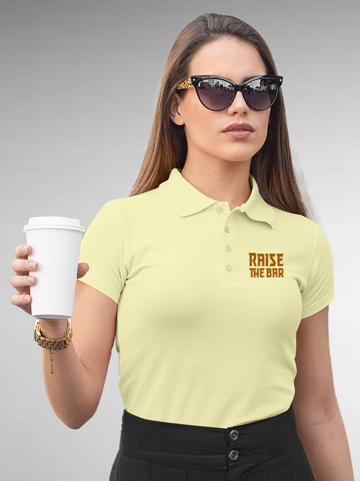 Model wearing Women's Yellow Polo T-shirt with 'Raise The Bar' design, offering effortless style and premium comfort