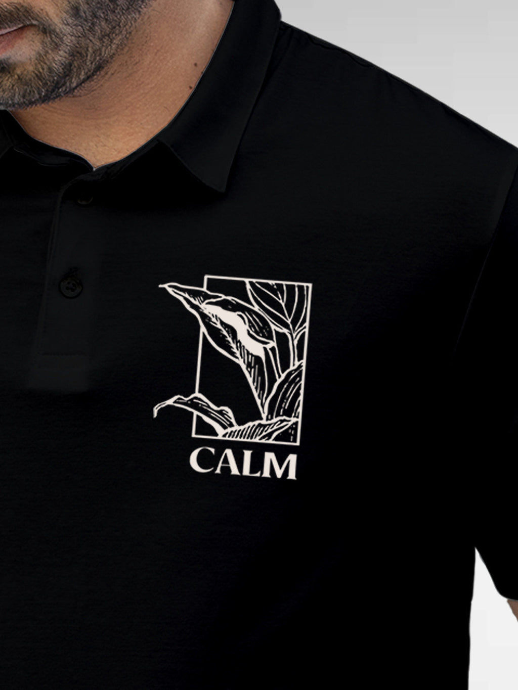 Close up of 'Calm' design on Men's Black Polo T-shirt, highlighting intricate details and vibrant print.