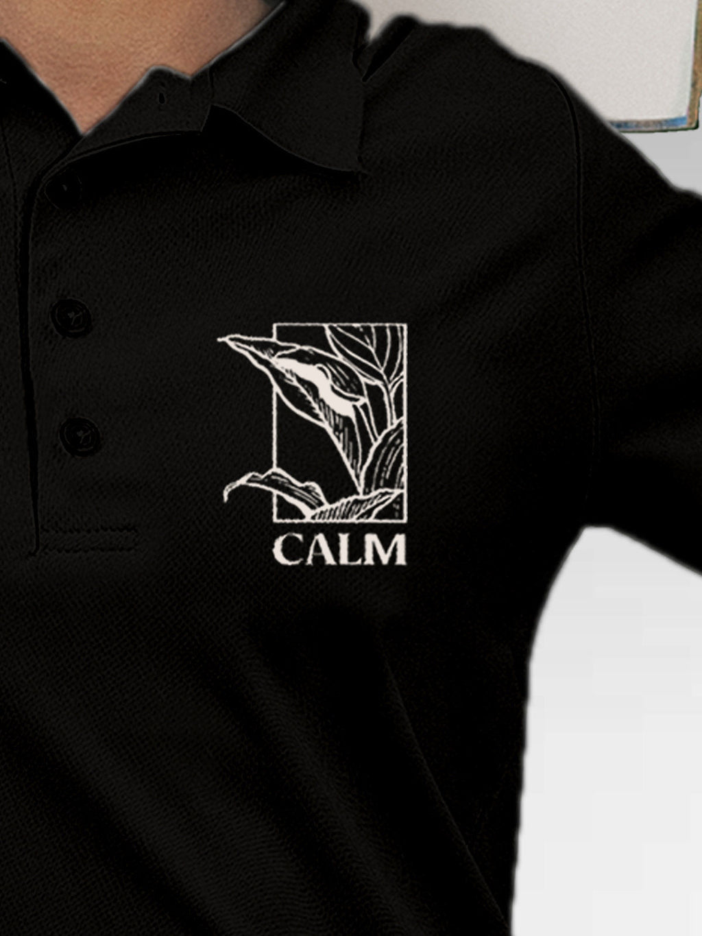 Close up of 'Calm' design on Women's Black Polo T-shirt, highlighting intricate details and vibrant print.