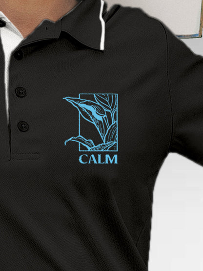 Close up of 'Calm' design on Women's Dark Grey Polo T-shirt, highlighting intricate details and vibrant print.