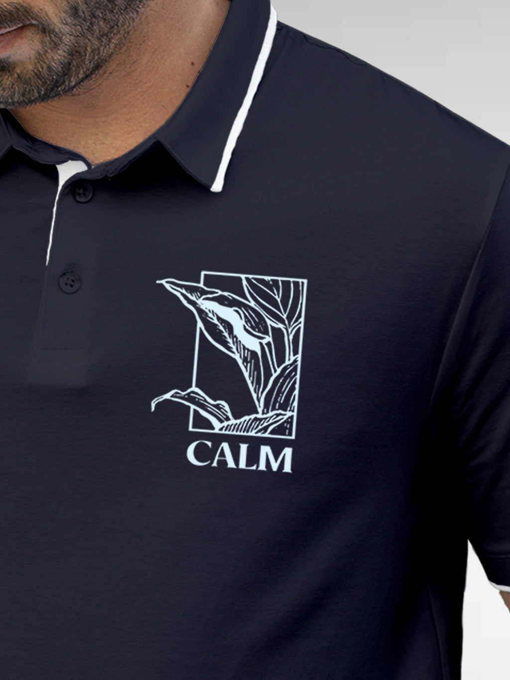 Close up of 'Calm' design on Men's Navy Blue Polo T-shirt, highlighting intricate details and vibrant print.
