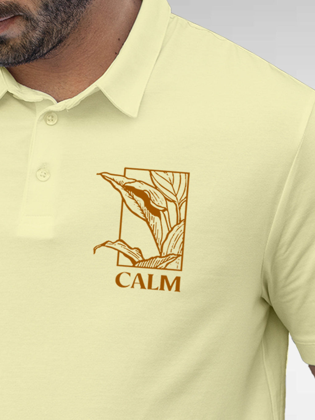 Close up of 'Calm' design on Men's Yellow Polo T-shirt, highlighting intricate details and vibrant print.