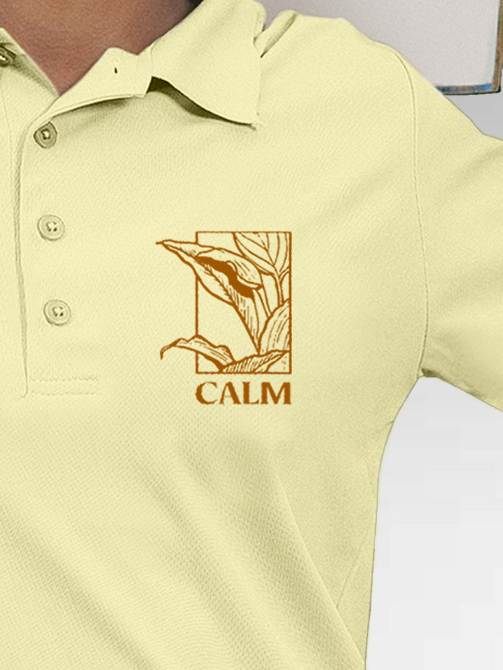 Close up of 'Calm' design on Women's Yellow Polo T-shirt, highlighting intricate details and vibrant print.