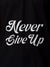 Close up of 'Never Give Up' design on Men's Black Polo T-shirt, highlighting intricate details and vibrant print.
