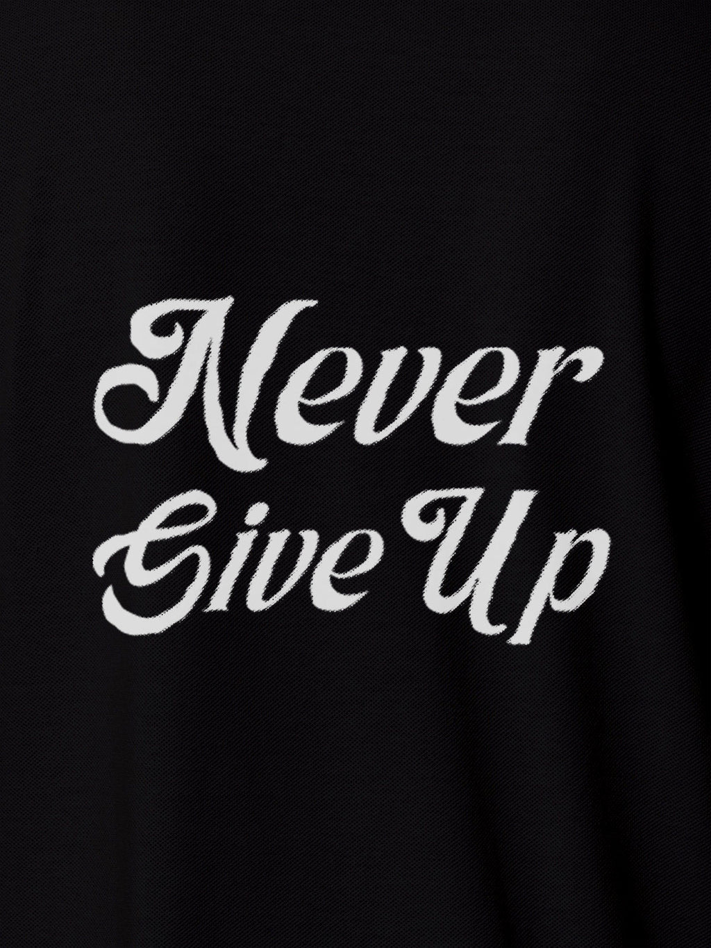 Close up of 'Never Give Up' design on Women's Black Polo T-shirt, highlighting intricate details and vibrant print.